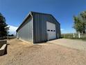 Spacious metal garage with a white door and concrete driveway, perfect for storage or a workshop at 1685 E 160Th Ave, Broomfield, CO 80023