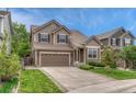 Well-kept home shows a lush lawn, driveway, complementary landscaping, and neutral colored siding at 4214 Kestrel Pl, Castle Rock, CO 80109