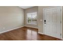 Bright living room boasts hardwood floors, large window, and neutral walls at 4214 Kestrel Pl, Castle Rock, CO 80109