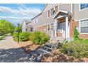 Attractive townhome with stone and siding exterior, set on landscaped grounds with a concrete walkway, creating a pleasant entryway at 12766 Jasmine St # D, Thornton, CO 80602