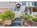 Welcoming front entrance with stone accents, featuring well-maintained landscaping and a concrete path leading to the door at 12766 Jasmine St # D, Thornton, CO 80602