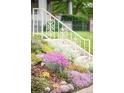 Beautiful garden with a variety of colorful flowers and lush greenery next to the front steps at 506 N Marion St, Denver, CO 80218