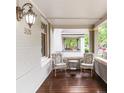 Inviting front porch featuring comfortable chairs, a small table, and decorative lighting at 506 N Marion St, Denver, CO 80218