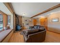 Warm and inviting living room with a charming stone fireplace and a cozy window nook at 6080 Kilimanjaro Dr, Evergreen, CO 80439