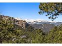 Panoramic mountain views with snow-capped peaks create a picturesque backdrop at 6080 Kilimanjaro Dr, Evergreen, CO 80439