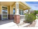 Close-up of the porch, with decorative brick pillars and white railing, adding charm to the entrance at 16062 E Geddes Dr # 150, Aurora, CO 80016