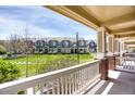 Covered porch offering a pleasant view of the well-maintained lawn and neighboring townhomes at 16062 E Geddes Dr # 150, Aurora, CO 80016
