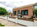 View of the home's exterior, highlighting its quaint facade and charming front patio area at 1803 E 36Th Ave, Denver, CO 80205