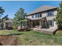 Spacious backyard featuring a well-maintained lawn, large patio, and partial view of the exterior elevation at 6877 Northstar Ct, Castle Rock, CO 80108
