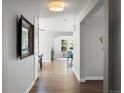 Bright hallway with hardwood floors and a decorative mirror welcomes you to the home at 6877 Northstar Ct, Castle Rock, CO 80108
