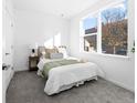 Cozy bedroom with a large window, neutral decor, and soft gray carpeting at 8711 E Hampden Ave # 20, Denver, CO 80231