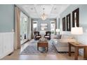 Bright living room with coffered ceilings, hardwood floors, and elegant decor at 11702 Perry St, Westminster, CO 80031