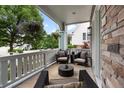 Inviting covered porch featuring comfortable seating and charming decorative touches at 11702 Perry St, Westminster, CO 80031