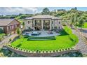 Expansive backyard featuring a lush lawn, patio with fire pit, and terraced landscaping perfect for outdoor enjoyment at 5388 Water Oak Cir, Castle Rock, CO 80108