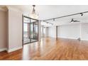 Spacious living area with hardwood floors, track lighting, and large sliding glass doors leading to outdoor balcony at 1551 Larimer St # 1803, Denver, CO 80202