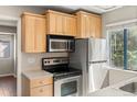 Kitchen featuring stainless steel appliances and light wood cabinetry at 6380 S Boston St # 391, Greenwood Village, CO 80111