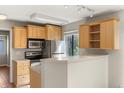 Bright kitchen with stainless appliances and light wood cabinetry at 6380 S Boston St # 391, Greenwood Village, CO 80111