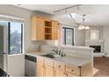 Bright eat-in kitchen with stainless appliances, light wood cabinetry, and a breakfast bar at 6380 S Boston St # 391, Greenwood Village, CO 80111