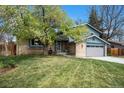 Charming two-story home featuring a brick facade, well-manicured lawn, and a two-car garage at 12175 W 68Th Pl, Arvada, CO 80004
