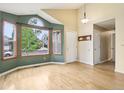 Bright living room with beautiful hardwood floors, a large window, and vaulted ceilings at 17943 E Bates Ave, Aurora, CO 80013