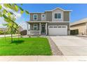 Beautiful two-story home with manicured lawn and a two-car garage at 9886 Ceylon Ct, Commerce City, CO 80022