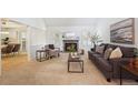 Cozy living room with fireplace, neutral decor, and comfortable seating at 7190 S Poplar Ct, Centennial, CO 80112
