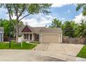 Charming single-story home with a well-maintained lawn and a two-car attached garage at 12665 Grove Ct, Broomfield, CO 80020