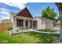 Charming home with manicured lawn, inviting front porch, and attached two-car garage at 12665 Grove Ct, Broomfield, CO 80020