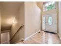 Bright foyer with hardwood floors and a decorative glass door at 6727 W Yale Ave, Lakewood, CO 80227