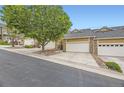 Street view of tan townhomes with two-car garages at 6727 W Yale Ave, Lakewood, CO 80227