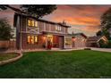 Beautiful two-story house with brick accents, lush lawn, and a welcoming front entrance at 7678 Newman St, Arvada, CO 80005