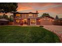 Charming home with a well-manicured lawn, a brick and siding facade, and a cozy front porch at 7678 Newman St, Arvada, CO 80005