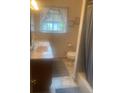 Compact bathroom with a granite vanity and shower with curtain at 14751 E 24Th Ave, Aurora, CO 80011
