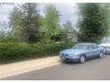 Well-maintained home with mature trees and lush landscaping at 14751 E 24Th Ave, Aurora, CO 80011