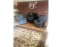 Cozy living room featuring a brick fireplace, hardwood floors, and classic decor at 14751 E 24Th Ave, Aurora, CO 80011