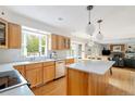 Open-concept kitchen with an island and views into a cozy living room with fireplace at 5292 Lichen Pl, Boulder, CO 80301