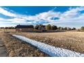 Charming single-story home with beautiful landscaping and an expansive front lawn at 1120 Antelope W Dr, Bennett, CO 80102