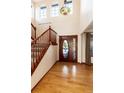 Elegant foyer with hardwood floors, a grand staircase, a decorative chandelier and a striking front door at 1120 Antelope W Dr, Bennett, CO 80102