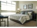 Comfortable bedroom with a large window, plush bed, and elegant decor at 2879 W Parkside Pl, Denver, CO 80221