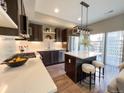 Stylish kitchen featuring a central island, modern appliances, and sleek cabinetry at 2879 W Parkside Pl, Denver, CO 80221