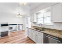 Bright kitchen with granite counters, stainless steel appliances, and view to adjacent dining area at 16652 E Gunnison Pl, Aurora, CO 80017