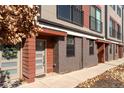 Townhome entrance with brick accents and an inviting front door with a holiday wreath at 2350 Tremont Pl # 19, Denver, CO 80205