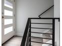 Bright entryway features modern door with sidelights and sleek black railing at 2350 Tremont Pl # 19, Denver, CO 80205