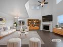 Bright, staged living room with high ceilings, a fireplace, and stylish, neutral-toned furniture at 8236 E 137Th Dr, Thornton, CO 80602
