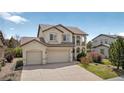 Charming two-story stucco home with a three-car garage, beautiful tile roof and well-maintained landscaping at 16043 Bridle Ridge Dr, Monument, CO 80132