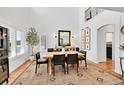 Elegant dining room offers a modern light fixture, bright natural light, and stylish decor at 8427 S Parfet Ct, Littleton, CO 80127