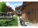 Brown home with an inviting walkway, flowerpots, attractive landscaping, and curb appeal at 283 Yank Ct, Lakewood, CO 80228