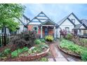 Charming home with colorful landscaping, brick accents, and a covered porch at 4467 W 30Th Ave, Denver, CO 80212