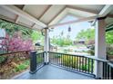 Inviting front porch with black railings and a view of the landscaped yard at 4467 W 30Th Ave, Denver, CO 80212
