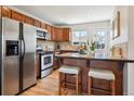 Well-equipped kitchen with stainless steel appliances, granite countertops, and breakfast bar seating at 2285 Fulton St, Aurora, CO 80010